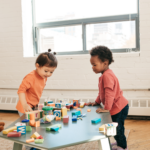 two children playing in a day care room to depict how we are proudly partnered with A child's haven