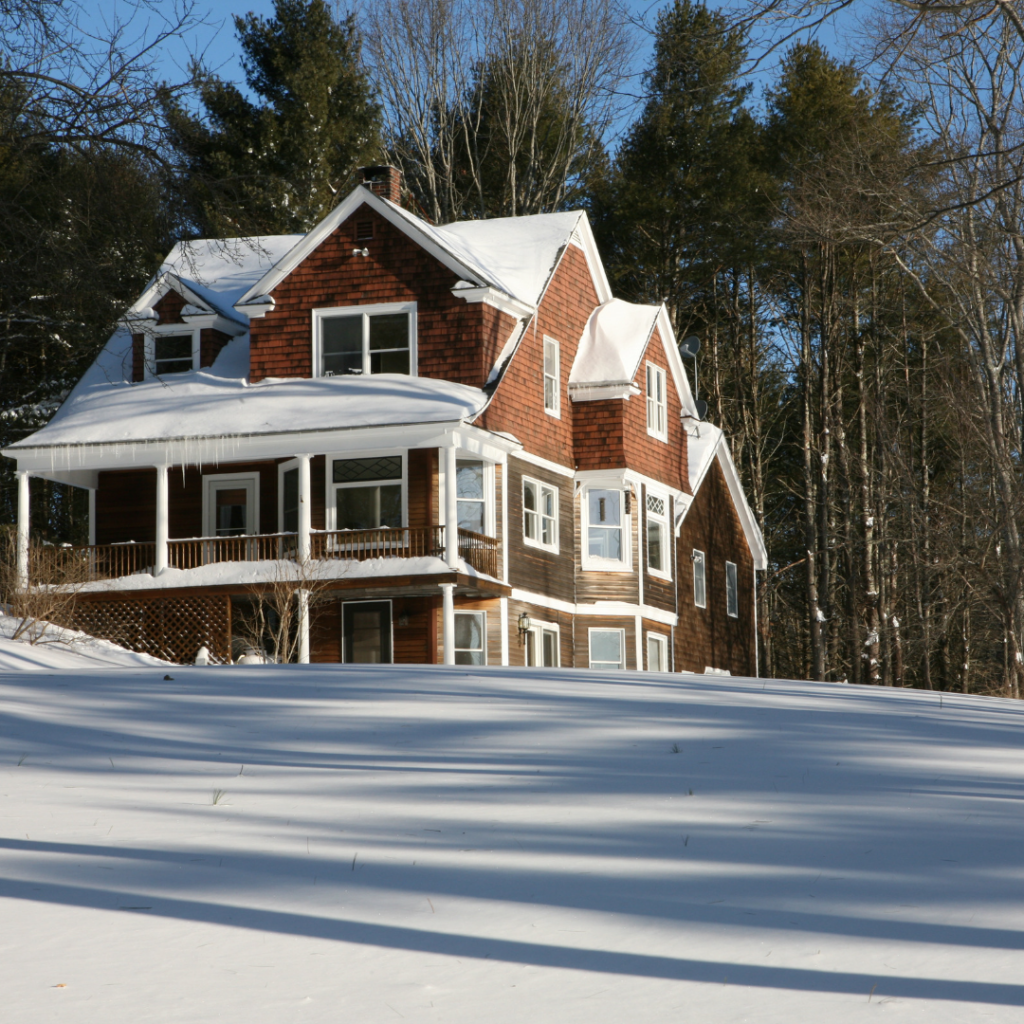 winter real estate. a brick home a top a snowy mountain