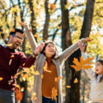 family throwing leaves in the air