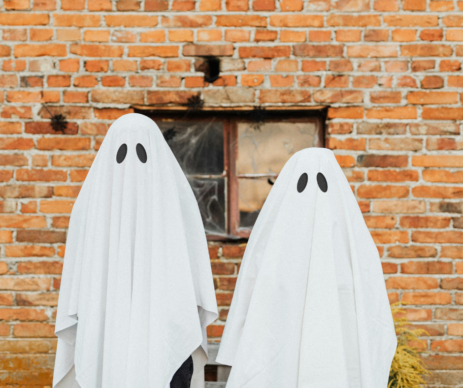 two people wearing sheets to look like ghosts